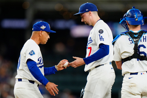Los Angeles Dodgers manager Dave Roberts, left, takes the ball from starting pitcher Blake Snell (7) as he's removed from the game during seventh inning Game 5 World Series playoff MLB baseball action against the Toronto Blue Jays in Los Angeles on Wednesday, Oct. 29, 2025. (Frank Gunn/The Canadian Press via AP) Los Angeles Dodgers manager Dave Roberts, left, takes the ball from starting pitcher Blake Snell (7) as he's removed from the game during seventh inning Game 5 World Series playoff MLB baseball action against the Toronto Blue Jays in Los Angeles on Wednesday, Oct. 29, 2025. (Frank Gunn/The Canadian Press via AP)