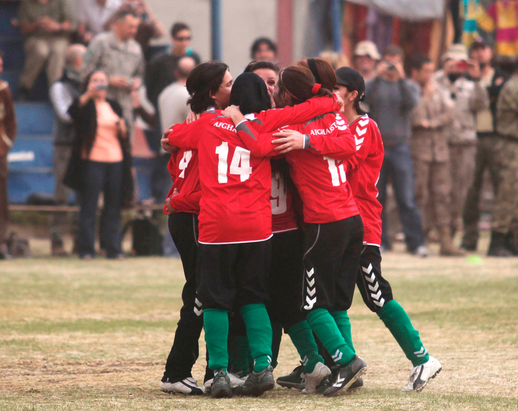 FILE - Members of the Afghan women's national soccer team celebrate their goal against the ISAF (International Security Assistance Force) female football team at the ISAF headquarters in Kabul, Afghanistan, Friday, Oct. 29, 2010. (AP Photo/Altaf Qadri, File)