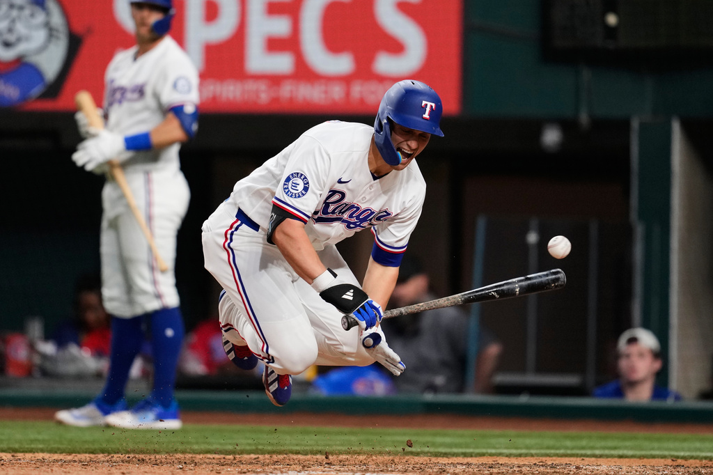 Texas Rangers' Corey Seager reacts to being hit by a pitch in the ninth inning of a baseball game against the Arizona Diamondbacks Monday, May 11, 2026, in Arlington, Texas. (AP Photo/Tony Gutierrez)