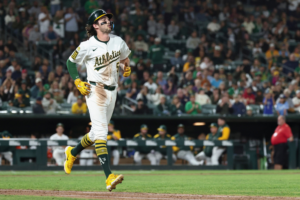 Athletics' Jacob Wilson takes first base after getting hit by a pitch from Kansas City Royals pitcher Carlos Estévez, not shown, during the ninth inning of a baseball game Saturday, Sept. 27, 2025, in West Sacramento, Calif. (AP Photo/Sara Nevis)