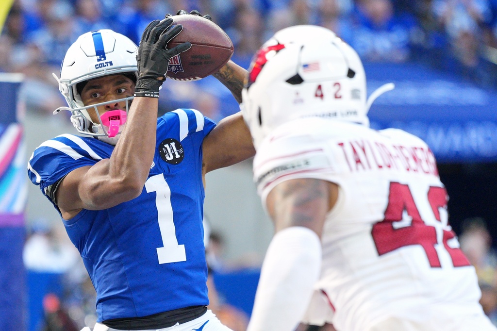 Indianapolis Colts' Josh Downs catches a touchdown pass in front of Arizona Cardinals' Dadrion Taylor-Demerson during the second half of an NFL football game Sunday, Oct. 12, 2025, in Indianapolis. (AP Photo/AJ Mast)