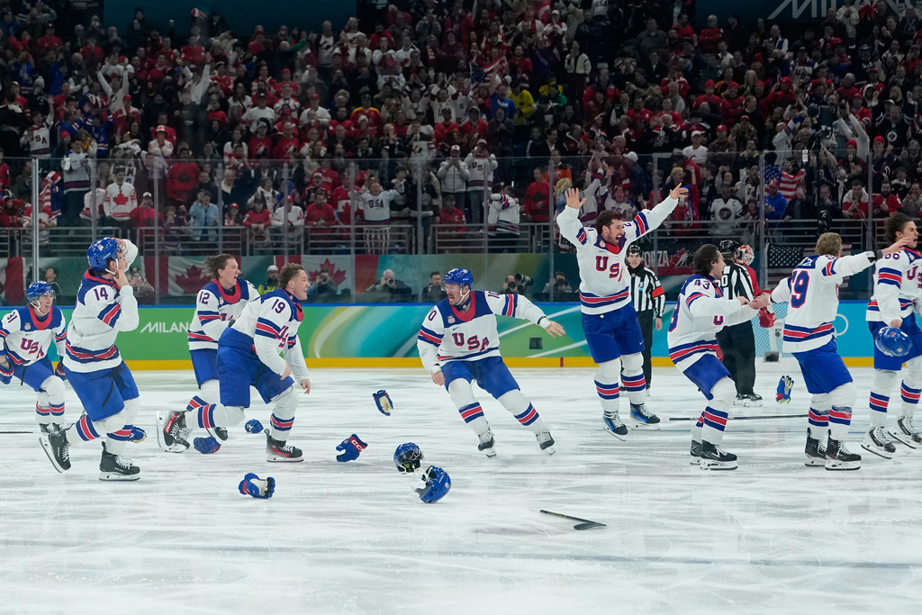 United States players celebrate after defeating Canada during a men's ice hockey gold medal game between Canada and the United States at the 2026 Winter Olympics, in Milan, Italy, Sunday, Feb. 22, 2026. (AP Photo/Petr David Josek)