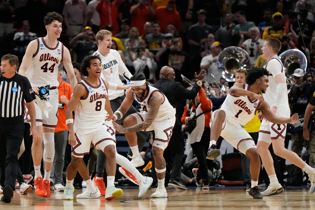 Illinois players celebrate after beating Iowa in an Elite Eight game in the NCAA college basketball tournament Saturday, March 28, 2026, in Houston. (AP Photo/Ashley Landis)