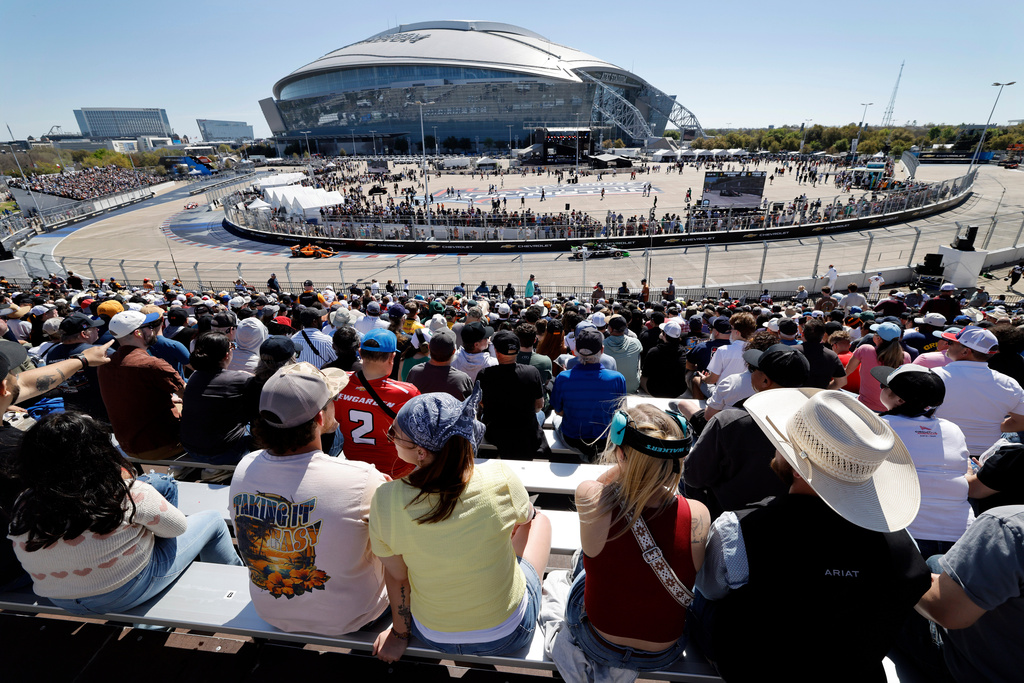 Race fans watch as IndyCar drivers race through the Horseshoe portion at the Grand Prix of Arlington auto race, Sunday, March 15, 2026, in Arlington, Texas. (Tom Fox/The Dallas Morning News via AP)