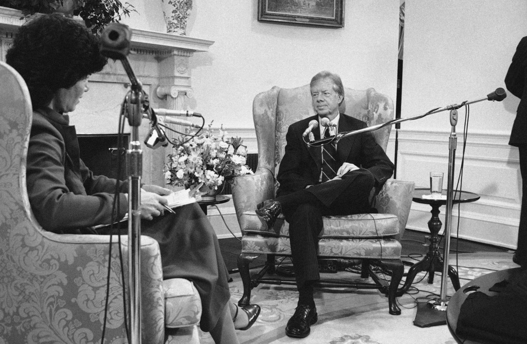 FILE - President Jimmy Carter speaks with Susan Stamberg just before a broadcast of a National Public Radio call-in program from Washington, Oct. 13, 1979 in Washington. (AP Photo/Charles Tasnadi, File)