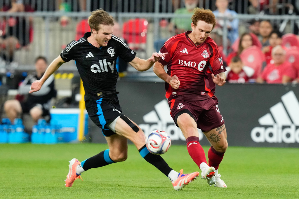 Toronto FC's Josh Sargent (right) and Charlotte FC's Henry Kessler (22) vie for the ball during the first half of a MLS soccer game in Toronto, Wednesday, Aug. 19, 2026. (Chris Young/The Canadian Press via AP)