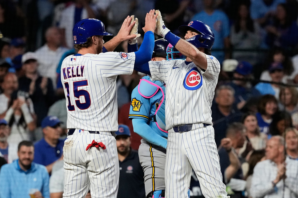 Chicago Cubs' Dansby Swanson, right, celebrates with Carson Kelly after hitting a two-run home run during the fifth inning of a baseball game against the Milwaukee Brewers in Chicago, Monday, May 18, 2026. (AP Photo/Nam Y. Huh)