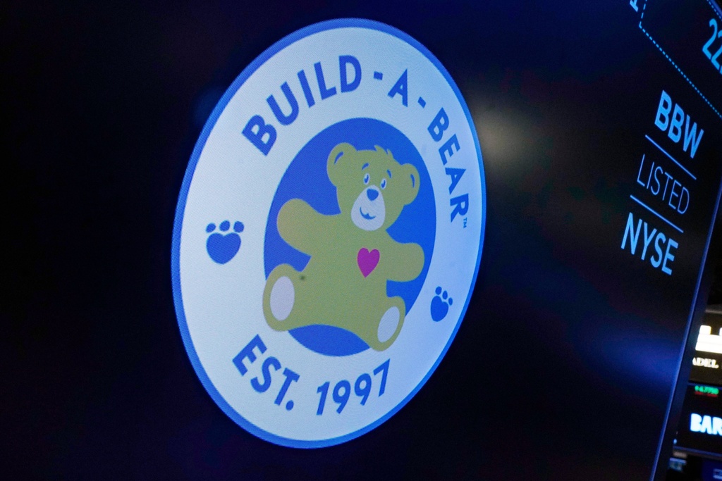 FILE - The logo for Build-A-Bear Workshop appears above a trading post on the floor of the New York Stock Exchange, Dec. 1, 2021. (AP Photo/Richard Drew, File)