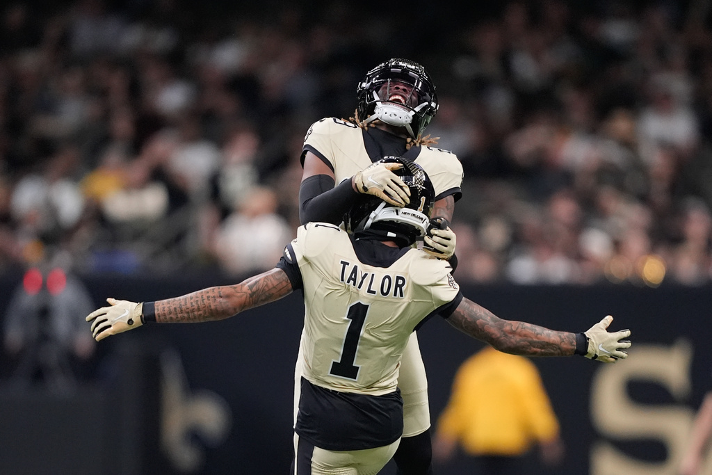New Orleans Saints cornerback Alontae Taylor (1) celebrates with cornerback Quincy Riley (29) after a sack during the second half of an NFL football game against the New York Jets, Sunday, Dec. 21, 2025, in New Orleans. (AP Photo/Gerald Herbert)