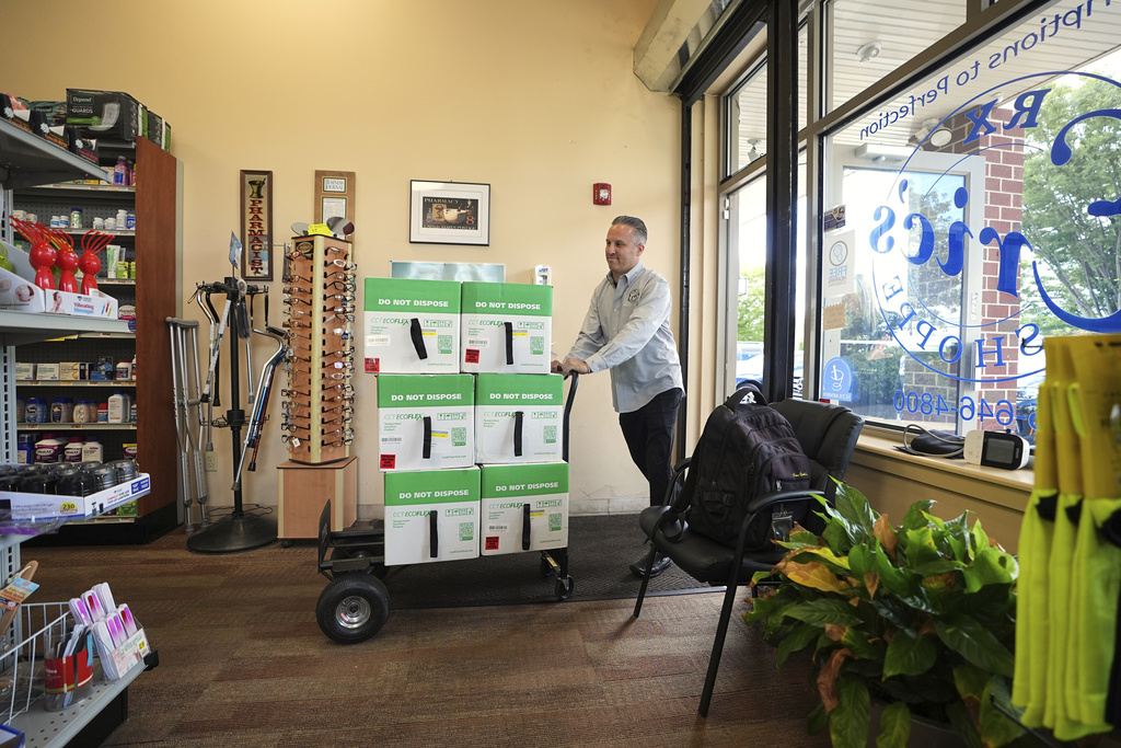 Marc Ost co-owner at Eric's Rx Shoppe wheels in part of a shipment of COVID-19 vaccines into the store in Horsham, Pa., Tuesday, Sept. 2, 2025. (AP Photo/Matt Rourke)