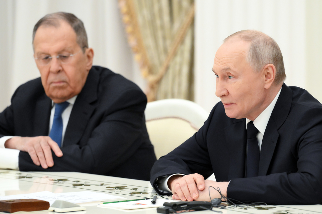 Russian President Vladimir Putin, right, accompanied by Russian Foreign Minister Sergey Lavrov, speaks with Hungarian Foreign Minister Peter Szijjarto, not pictured, at the Senate Palace of the Kremlin in Moscow, Wednesday, March 4, 2026. (Grigory Sysoyev, Sputnik, Kremlin Pool Photo via AP)