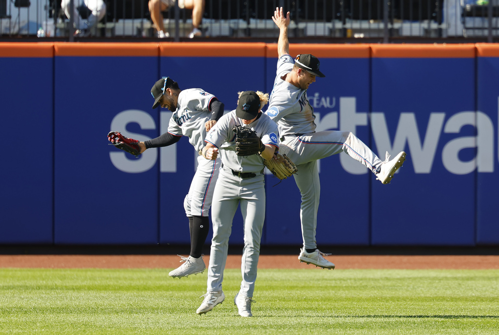 From left to right, Miami Marlins outfielders Victor Mesa Jr., Joey Wiemer and Jakob Marsee celebrate after defeating the New York Mets, Sunday, Aug. 31, 2025, in New York. (AP Photo/Noah K. Murray)
