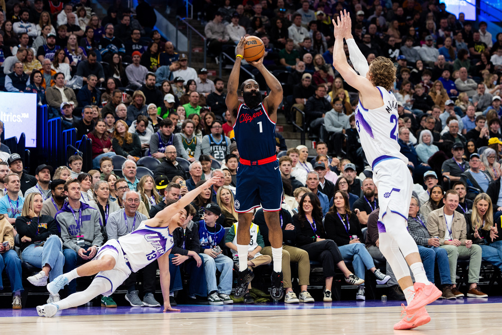 Utah Jazz guard Walter Clayton Jr. (13) and forward Lauri Markkanen, right, attempt to defend Los Angeles Clippers guard James Harden (1) as he shoots during the second half of an NBA basketball game, Tuesday, Jan. 27, 2026, in Salt Lake City. (AP Photo/Anna Fuder)