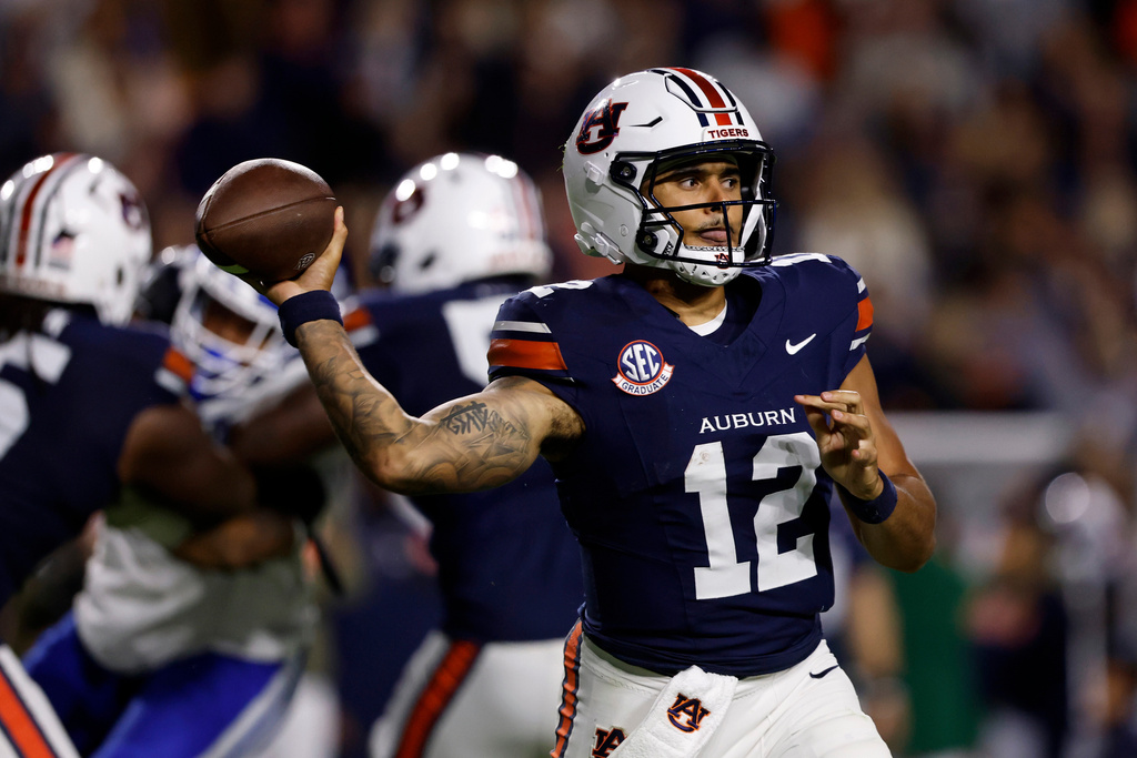 Auburn quarterback Ashton Daniels (12) throws a pass during the first half of an NCAA college football game against Kentucky, Saturday, Nov. 1, 2025, in Auburn, Ala. (AP Photo/Butch Dill)