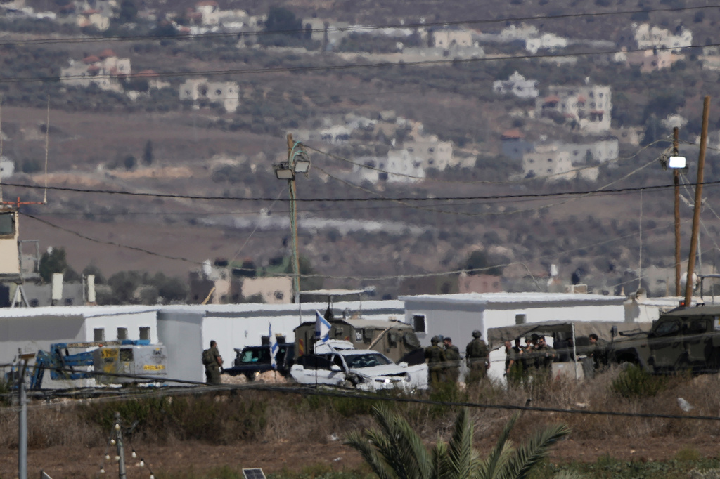 Israeli security forces work at the scene where the military said it killed a Palestinian man who attempted to carry out a ramming attack against soldiers at an intersection near the West Bank city of Jenin, Sunday, Sept. 20, 2026. (AP Photo/Majdi Mohammed)
