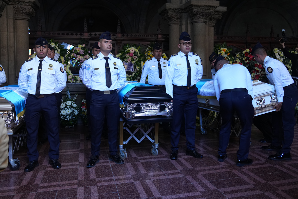 The wake for police officers killed while retaking control of three prisons is held at the Interior Ministry in Guatemala City, Monday, Jan. 19, 2026. (AP Photo/Moises Castillo)