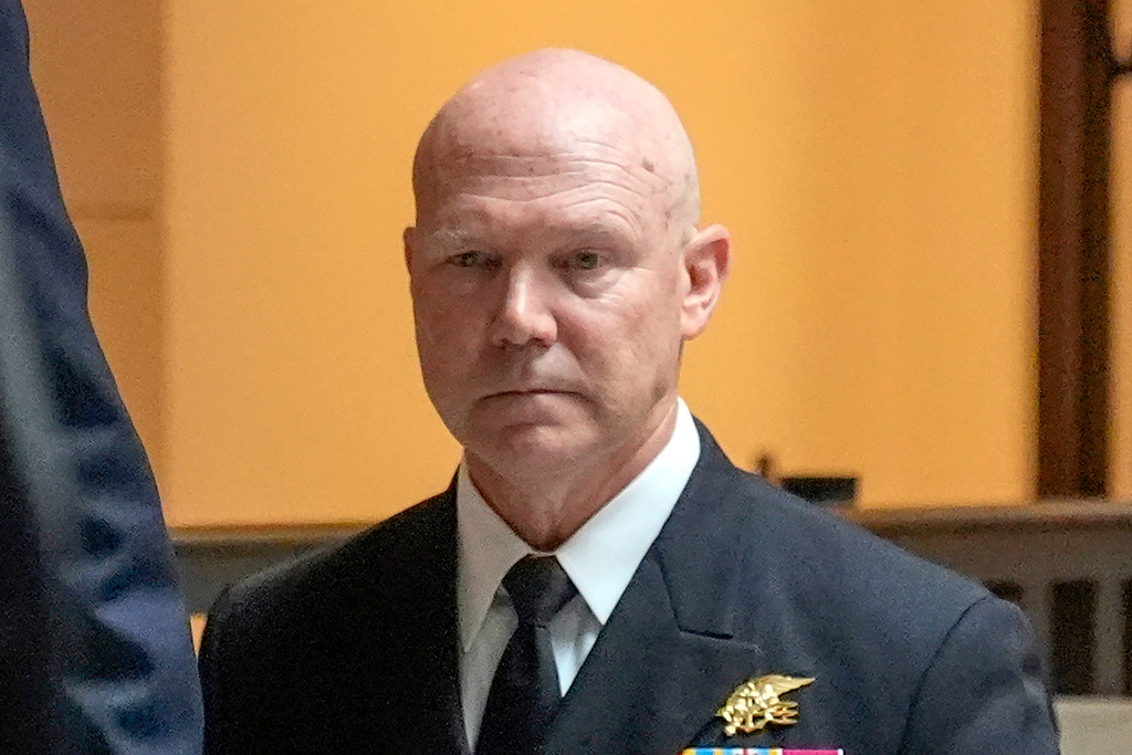 U.S. Navy Adm. Frank M. Bradley walks to a meeting with senators on Capitol Hill, Thursday, Dec. 4, 2025, in Washington. (AP Photo/Mark Schiefelbein)