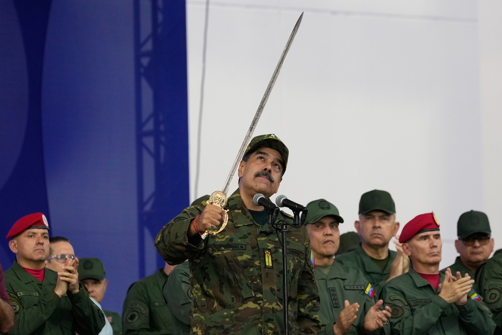 FILE - Venezuelan President Nicolas Maduro brandishes a sword said to have belonged to independence hero Simon Bolivar during a civic-military event at the military academy in Caracas, Venezuela, Nov. 25, 2025. (AP Photo/Ariana Cubillos, File)