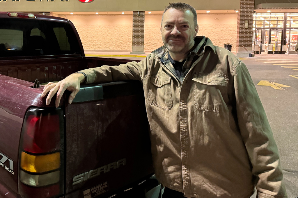 Travis Garcia, a 45-year-old supporter of President Donald Trump, poses for a picture as he leans against his pickup truck in Castle Rock, Colo., Jan. 5, 2026. (AP Photo/Jesse Bedayn)