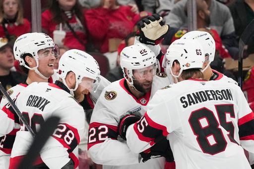 Ottawa Senators right wing Michael Amadio (22), center, celebrates his goal on Chicago Blackhawks goaltender Spencer Knight during the second period of an NHL hockey game, Tuesday, Oct. 28, 2025, in Chicago. (AP Photo/Erin Hooley) Ottawa Senators right wing Michael Amadio (22), center, celebrates his goal on Chicago Blackhawks goaltender Spencer Knight during the second period of an NHL hockey game, Tuesday, Oct. 28, 2025, in Chicago. (AP Photo/Erin Hooley)
