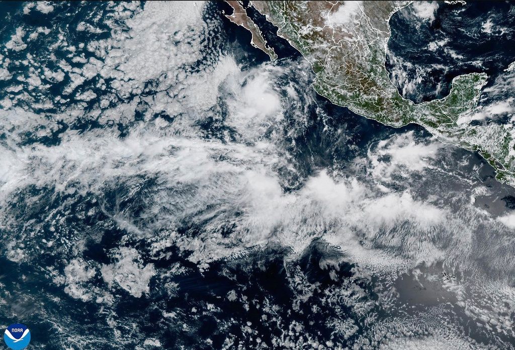 In this satellite image released by NOAA, Tropical Storm Mario is seen developing off the western Mexican coast, Sunday, Sept. 14, 2025. (NOAA via AP)