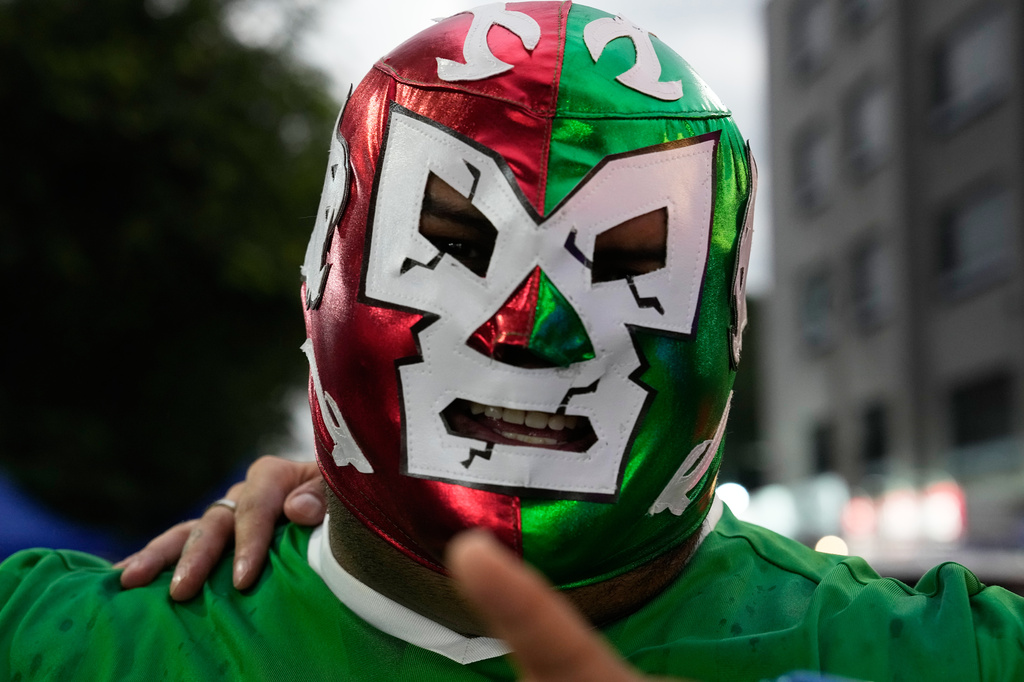 A Lucha wrestling fan wears a fighter masks before entering Arena Mexico in Mexico City, Friday, June 26, 2026. (AP Photo/Marco Ugarte)
