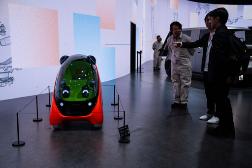 Members of media and guests look at the Toyota's Kids mobi during the press day of the Japan Mobility Show, in Tokyo, Thursday, Oct. 30, 2025. (AP Photo/Louise Delmotte) Members of media and guests look at the Toyota's Kids mobi during the press day of the Japan Mobility Show, in Tokyo, Thursday, Oct. 30, 2025. (AP Photo/Louise Delmotte)