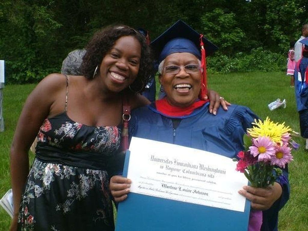 In this undated photo made available by Morenike Evans, Morenike Joela Evans (left) and her mother, Marlene Johnson, pose during Johnson's Howard University graduation with a master's degree in Religious Studies in Washington. (Morenike Evans via AP)