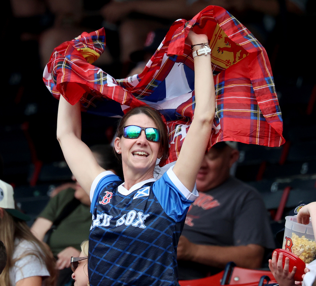 A Scotland men's national soccer team fan sings and dances before a baseball game between the Boston Red Sox and the Texas Rangers, Sunday, June 14, 2026, in Boston. (AP Photo/Mark Stockwell)