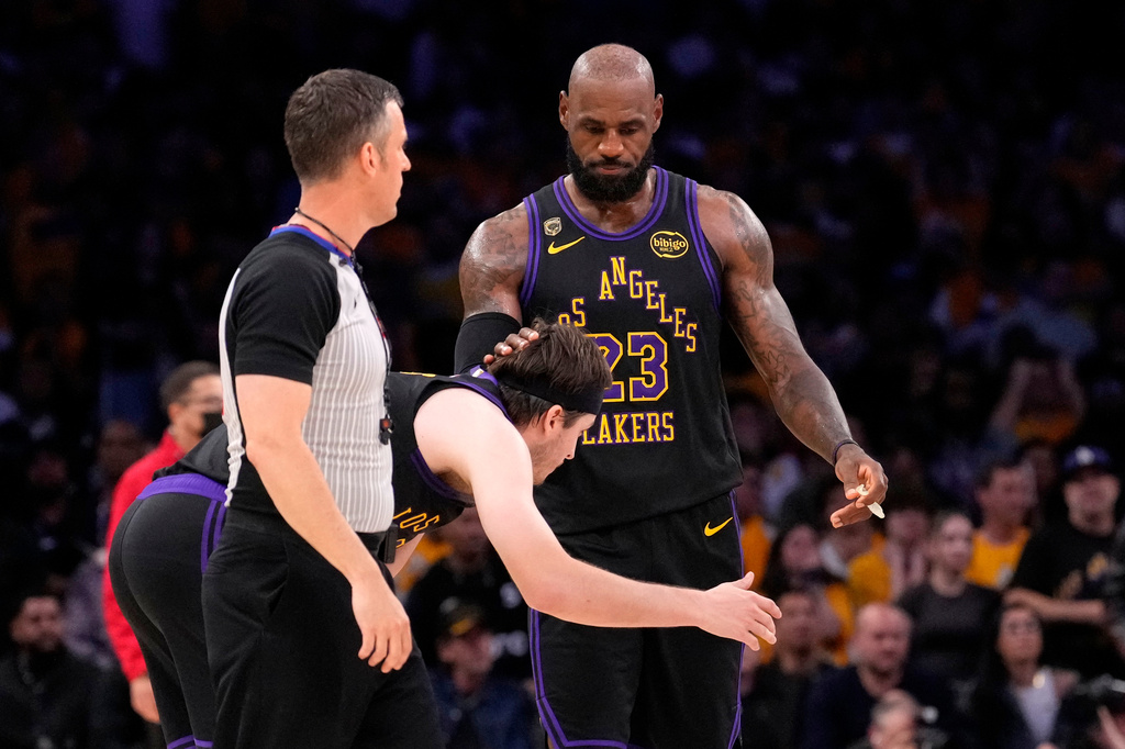 Los Angeles Lakers forward LeBron James, right, pats guard Austin Reaves on the head after Reaves missed a three-point shot with 11 seconds left in Game 4 of a second-round NBA basketball playoffs series against the Oklahoma City Thunder, Monday, May 11, 2026, in Los Angeles. (AP Photo/Mark J. Terrill)