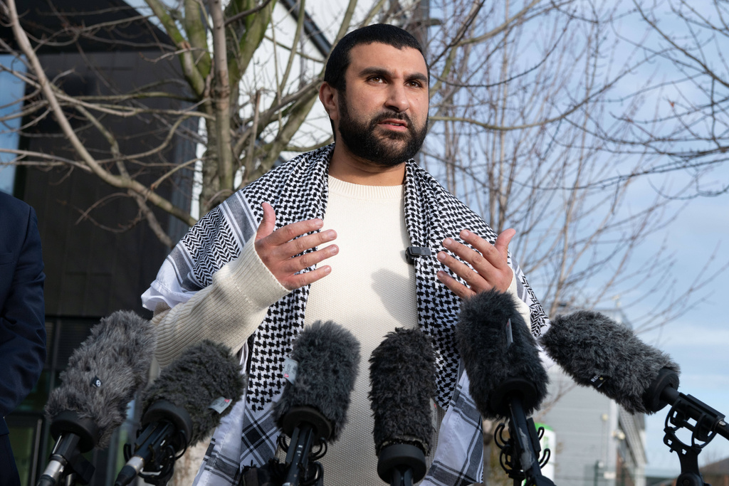 British political commentator Sami Hamdi speaks to the media in London, Thursday, Nov. 13, 2025, on his return to the U.K. after he was arrested by Immigration and Customs Enforcement on Oct. 26 while on a speaking tour in the U.S.. (AP Photo/Thomas Krych)