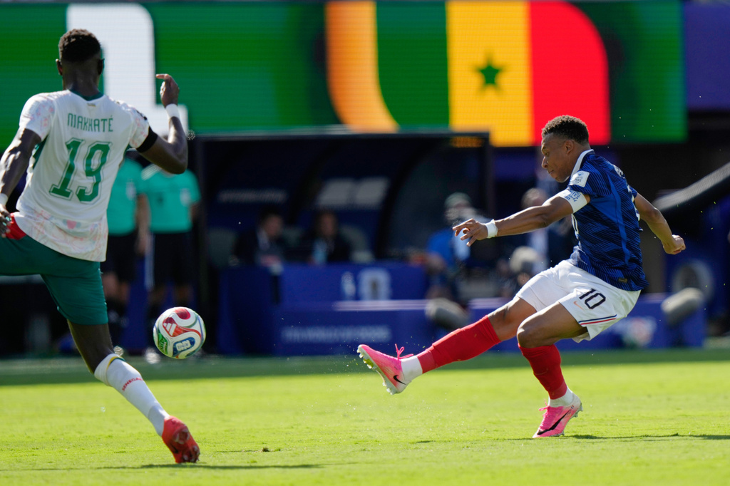 France's Kylian Mbappe (10) shoots and scores their throw goal during the World Cup Group I soccer match between France and Senegal in East Rutherford, N.J., near New York, Tuesday, June 16, 2026. (AP Photo/Steve Luciano)