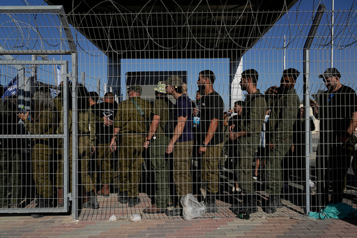 FILE - Israeli soldiers gather at the gate to the Sde Teiman military base, as people protest in support of soldiers being questioned for detainee abuse, July 29, 2024. (AP Photo/Tsafrir Abayov, File) FILE - Israeli soldiers gather at the gate to the Sde Teiman military base, as people protest in support of soldiers being questioned for detainee abuse, July 29, 2024. (AP Photo/Tsafrir Abayov, File)