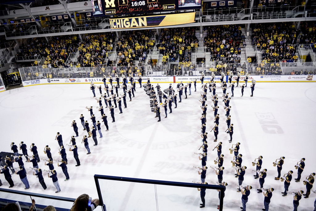 FILE - The Michigan Marching Band performs at the end of the first period during an NCAA college men's hockey game between Michigan State and Michigan, Jan. 9, 2016, in Ann Arbor, Mich. (Junfu Han/The Ann Arbor News via AP, File)