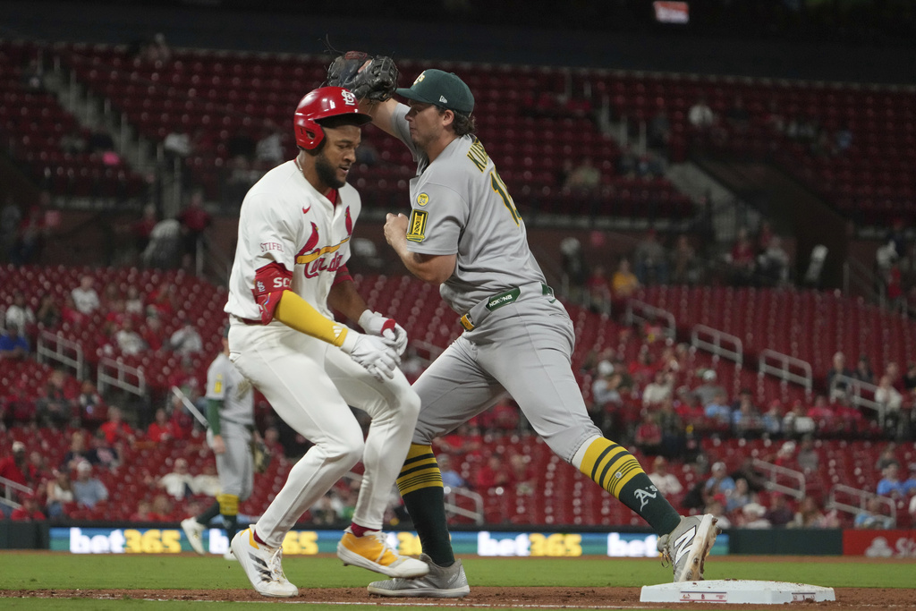 St. Louis Cardinals' Victor Scott II, left, grounds out as Athletics first baseman Nick Kurtz handles the throw during the eighth inning of a baseball game Tuesday, Sept. 2, 2025, in St. Louis. (AP Photo/Jeff Roberson)