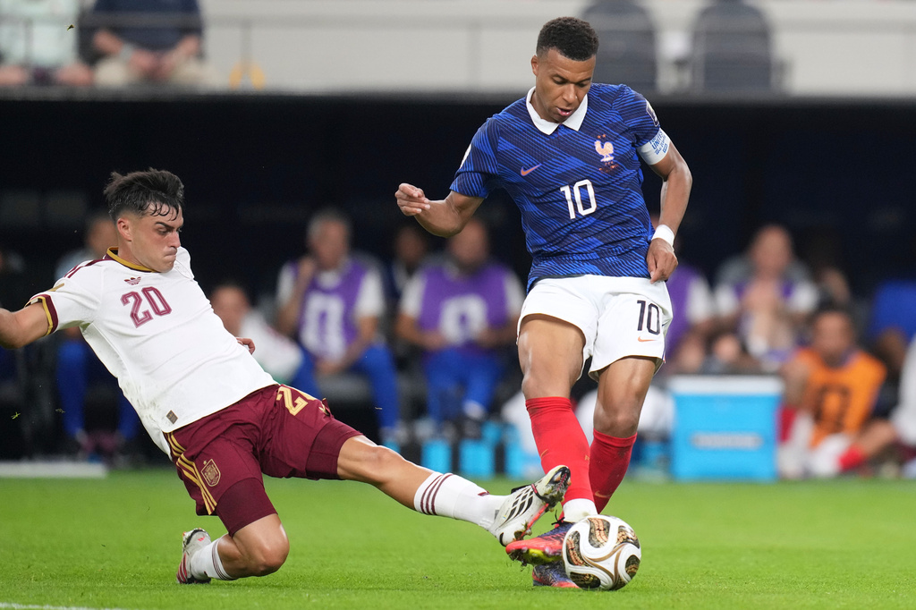 Spain's Dani Olmo (10) tries to poke the ball away from France's Kylian Mbappe (10) during the World Cup semifinal soccer match between France and Spain in Arlington, Texas, near Dallas, Tuesday, July 14, 2026. (AP Photo/Eric Gay)
