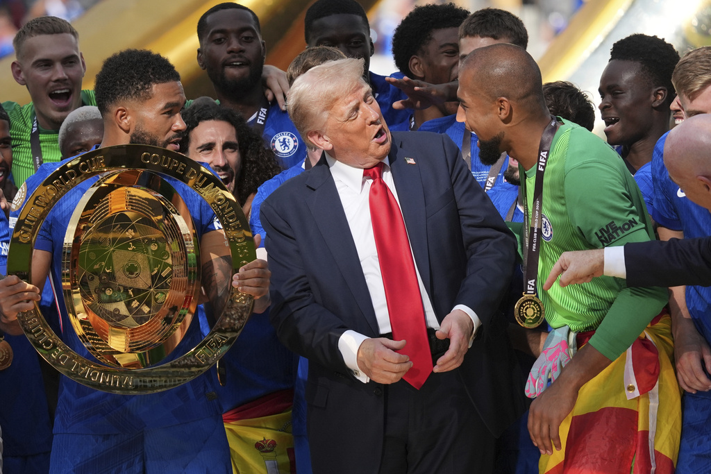 FILE - President Donald Trump, center, speaks with Chelsea's goalkeeper Robert Sanchez, right, as Chelsea's Reece James holds the championship trophy following the Club World Cup final soccer match in East Rutherford, N.J., July 13, 2025. (AP Photo/Jacquelyn Martin, File)