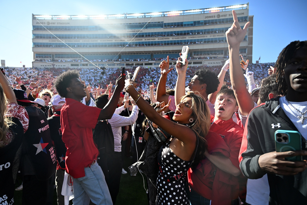 Texas Tech fans storm the field after the team's win over BYU in a NCAA college football game, Saturday, Nov. 8, 2025, in Lubbock, Texas. (AP Photo/Annie Rice)