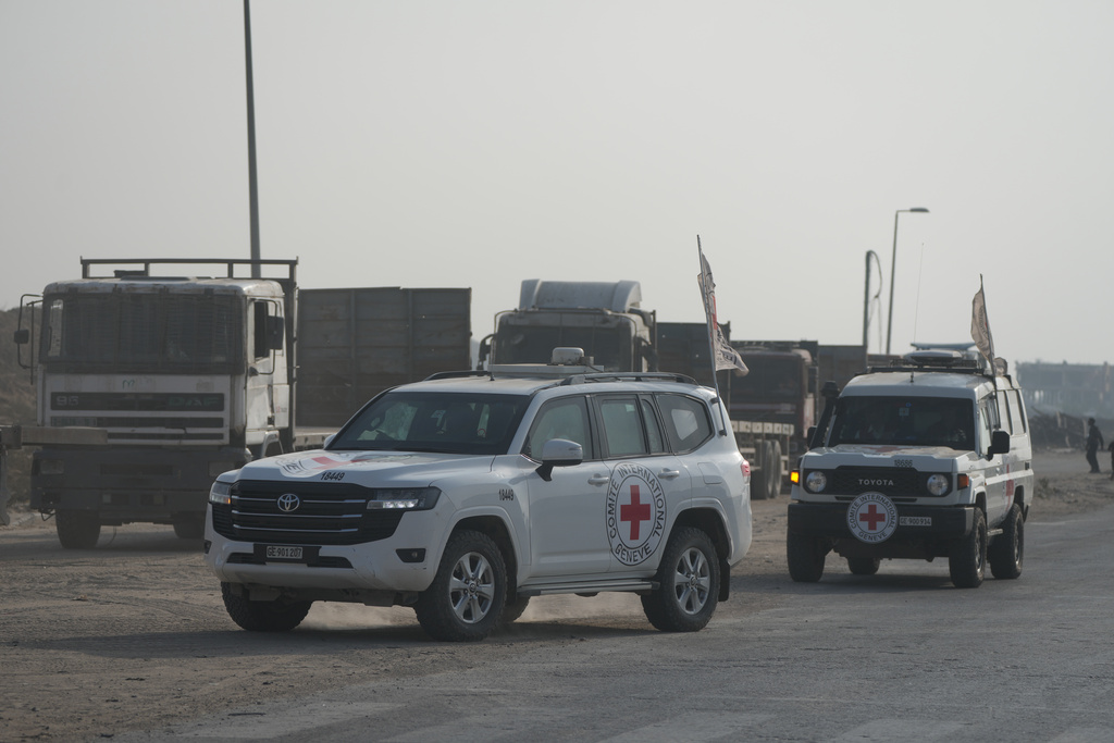 Red Cross convoy carrying what Hamas claims is the remains of an Israeli soldier who was killed in Gaza in 2014 and whose body has been held in Gaza since. makes its way toward the border crossing with Israel, to be transferred to Israeli authorities, in Deir al-Balah, Gaza Strip, Sunday, Nov. 9, 2025. (AP Photo/Jehad Alshrafi)