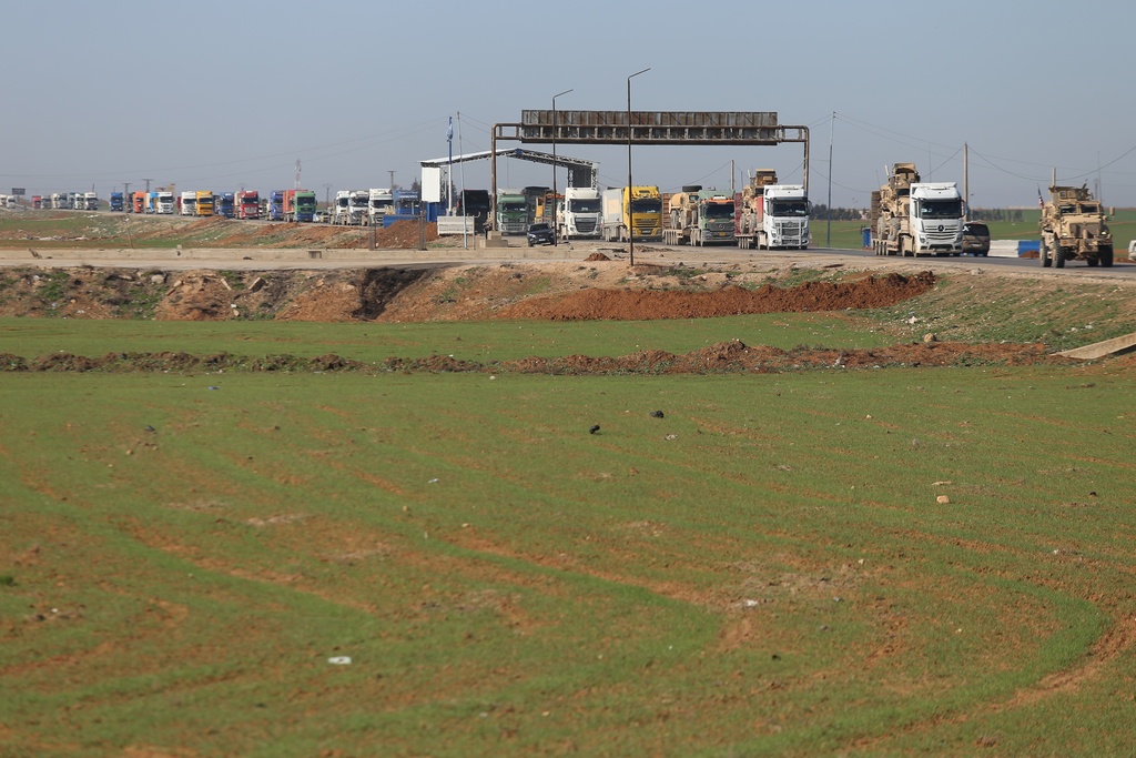 A convoy carrying U.S. Army vehicles drives away from the International Coalition's Qasrak Base, its largest base in northeastern Syria, heading toward Iraqi territory on the outskirts of Qamishli, eastern Syria, Monday, Feb. 23, 2026.(AP Photo/Baderkhan Ahmad)