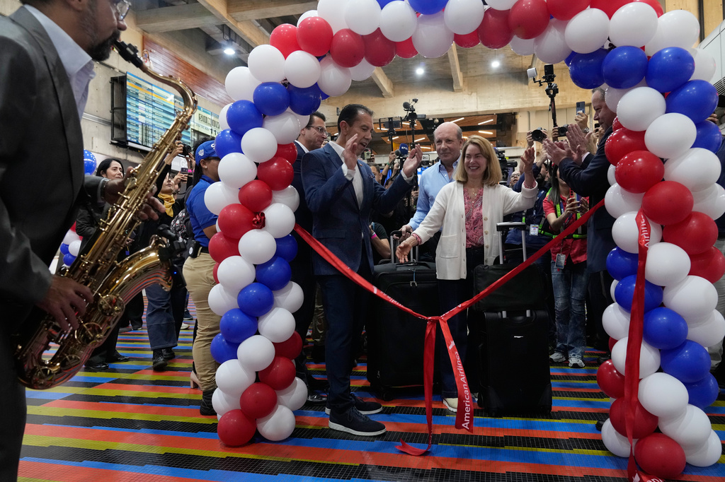 Passengers line up to check in for a U.S.-bound commercial flight at Simon Bolivar International Airport in Maiquetia, Venezuela, Thursday, April 30, 2026, as direct air service between the United States and Venezuela resumes after seven years. (AP Photo/Ariana Cubillos)