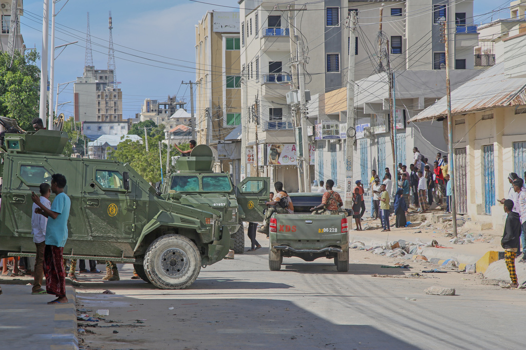 Armored vehicles carrying Somali security forces patrol a street after supporters of opposition political figures and state security forces clashed in Mogadishu, Somalia, Thursday, June 4, 2026. (AP Photo/Farah Abdi Warsameh)