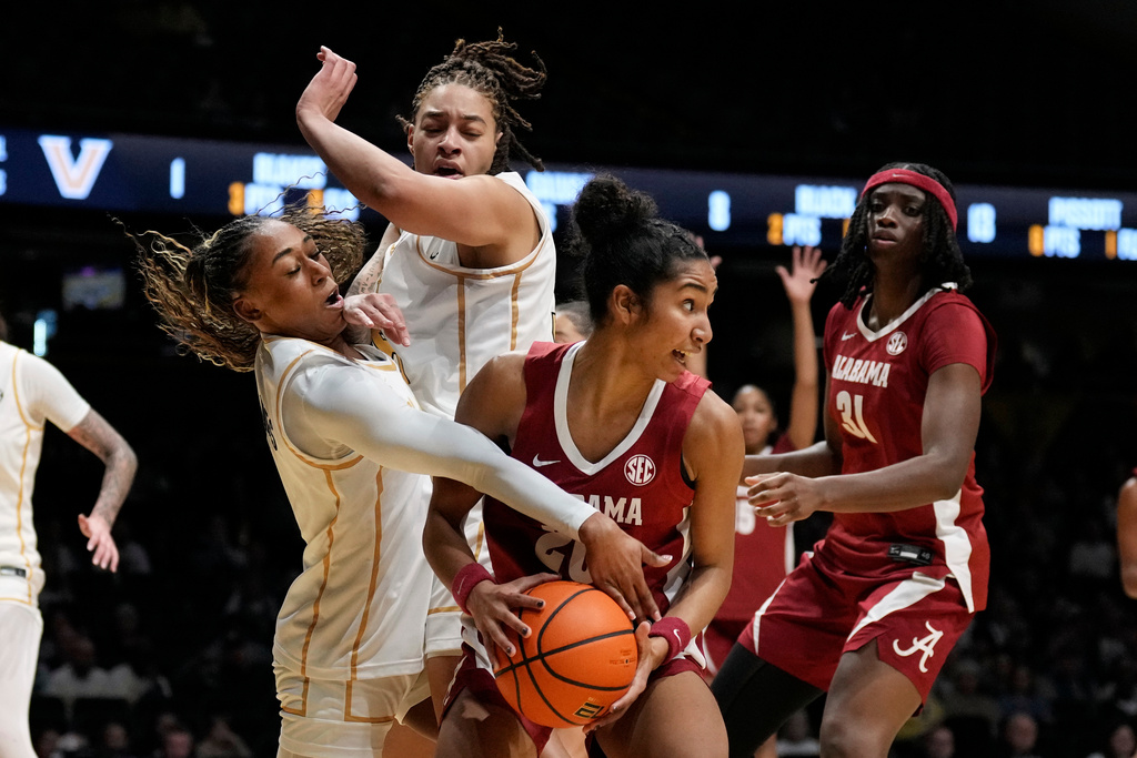 Alabama's Diana Collins (20) is defended by Vanderbilt's Mikayla Blakes, left, and Sacha Washington, second from left, in the first half ofan NCAA college basketball game Thursday, Feb. 26, 2026, in Nashville, Tenn. (AP Photo/Mark Humphrey)