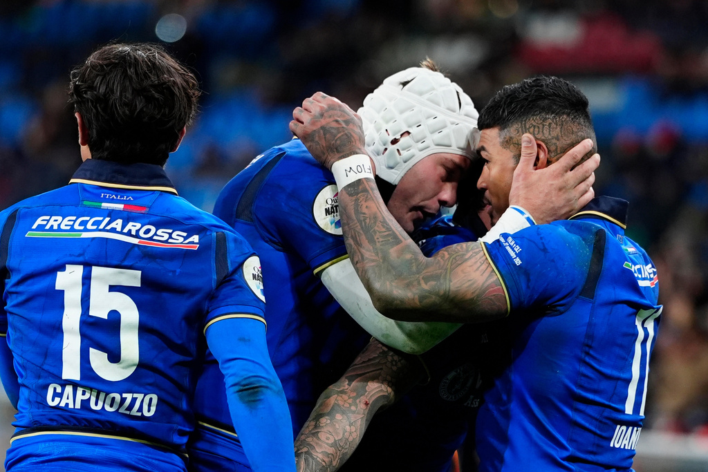 Italy's Manuel Zuliani, center, Monty Ioane, right, and Ange Capuozzo celebrate during a Quilter Nations Series 2025 rugby match against Chile, Saturday, Nov. 22, 2205, in Genoa, Italy. (Fabio Ferrari/LaPresse via AP)
