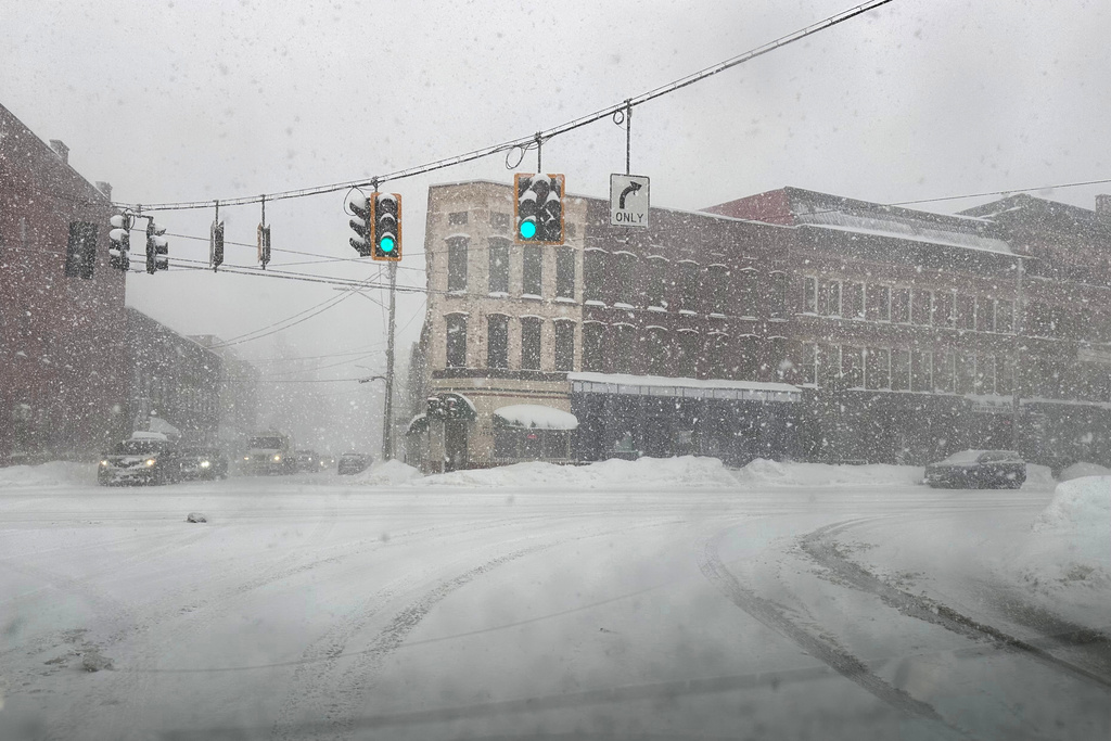 Fresh snow blows through an intersection in Lowville, N.Y., on Thursday, Jan. 22, 2026. (AP Photo/Cara Anna)