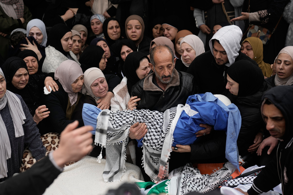 Palestinians mourn at the funeral of four members of the Odeh family who were killed in their car by Israeli security forces during an army operation in Tammun, West Bank, Sunday, March 15, 2026. (AP Photo/Majdi Mohammed)