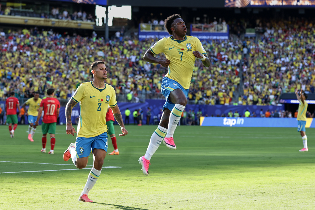 Brazil's Vinicius Junior (7) celebrates with teammate Bruno Guimaraes (8) after scoring during the World Cup Group C soccer match against Morocco in East Rutherford, N.J., near New York, Saturday, June 13, 2026. (AP Photo/Adam Hunger)
