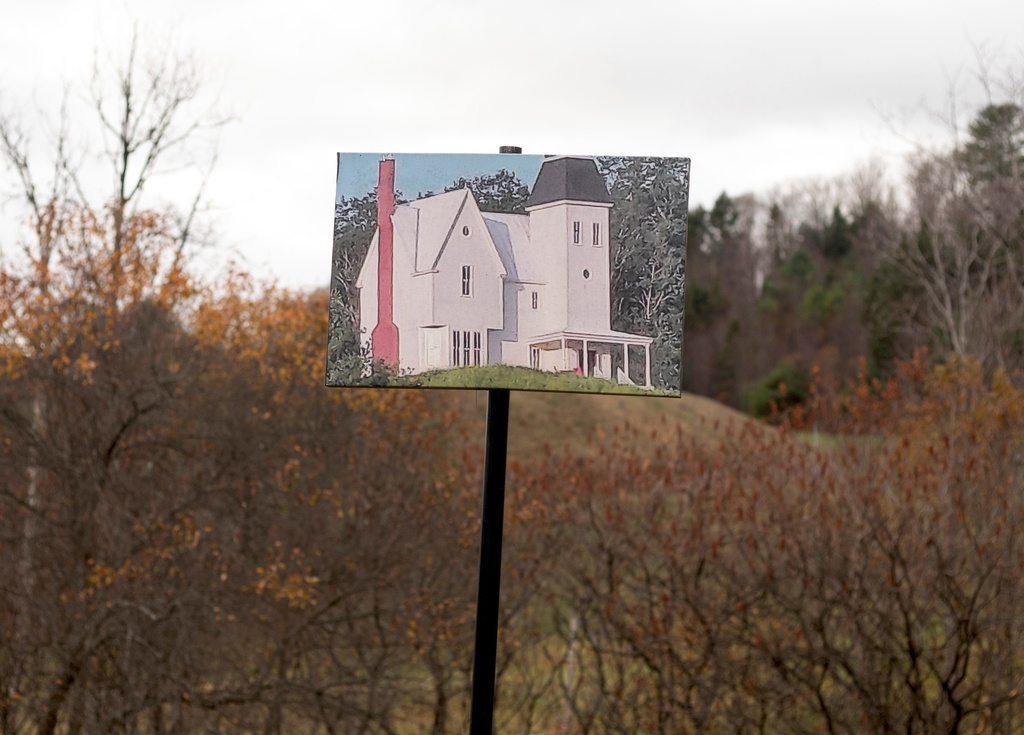 A photo of the home featured in the Beetlejuice films is pictured on a pole in front of the hill where the house was constructed and later taken down during filming in East Corinth, Vt., Tuesday, Oct. 28, 2025. (AP Photo/Amanda Swinhart)
