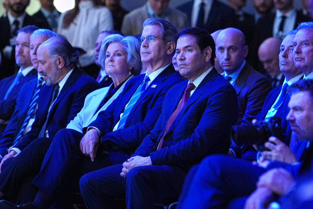 United States Secretary of State Marco Rubio, center, right, sits with U.S. Treasury Secretary Scott Bessent, center, and White House chief of staff Susie Wiles, center left, as they listen to the address of President Donald Trump during the Annual Meeting of the World Economic Forum in Davos, Switzerland, Wednesday, Jan. 21, 2026. (AP Photo/Evan Vucci)