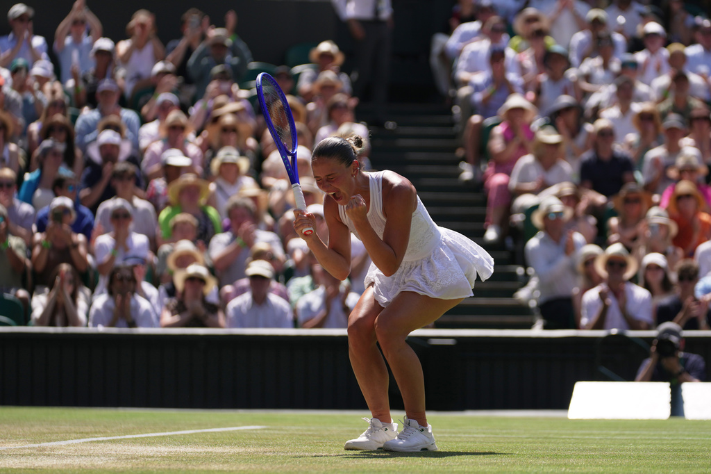 Marta Kostyuk of Ukraine celebrates her victory against Jasmine Paolini of Italy in their quarter-final women's singles match at the Wimbledon Tennis Championships in London, Wednesday, July 8, 2026. (AP Photo/Brian Inganga)